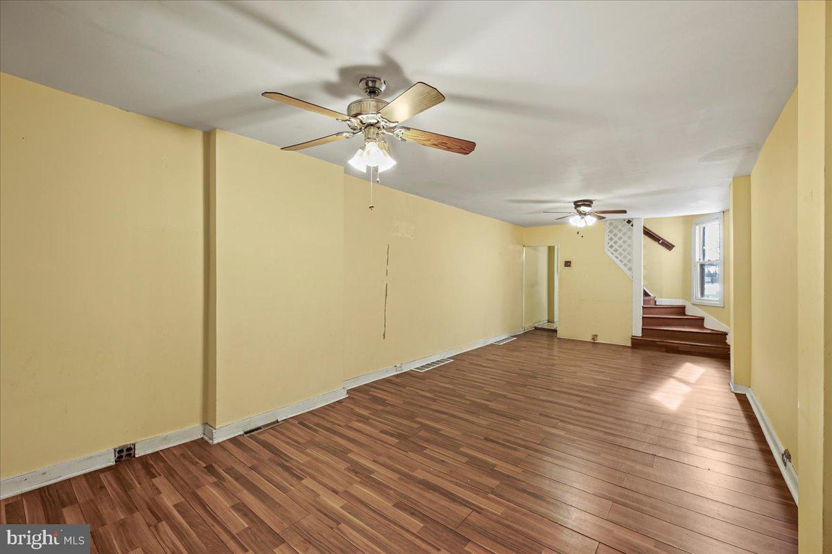 1267 Nottingham Way Hamilton, NJ 08609 - Photo 6 of 24 a view of a big room with wooden floor staircase and a ceiling fan