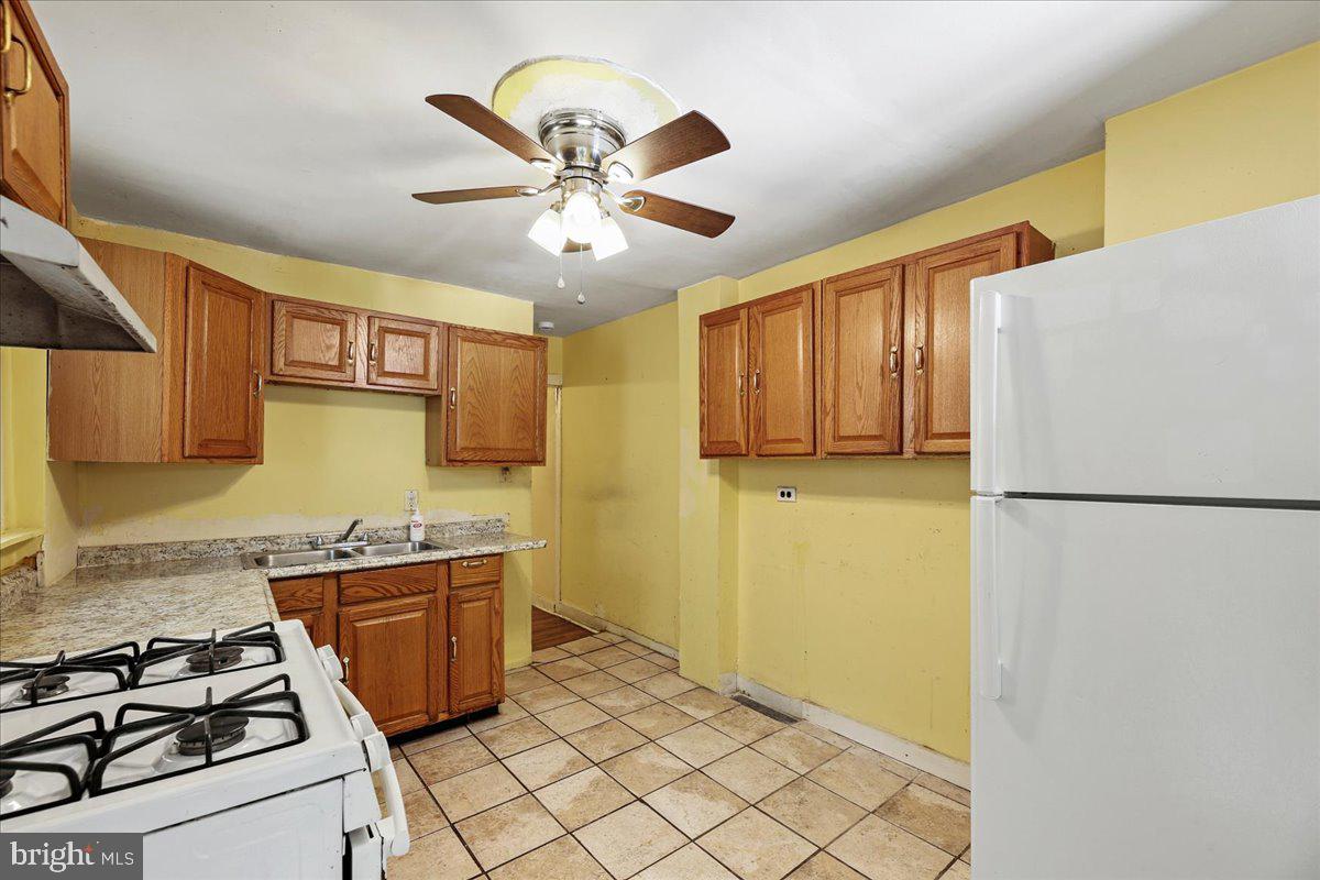 1267 Nottingham Way Hamilton, NJ 08609 - Photo 7 of 24 a kitchen with stainless steel appliances a stove a refrigerator and a sink