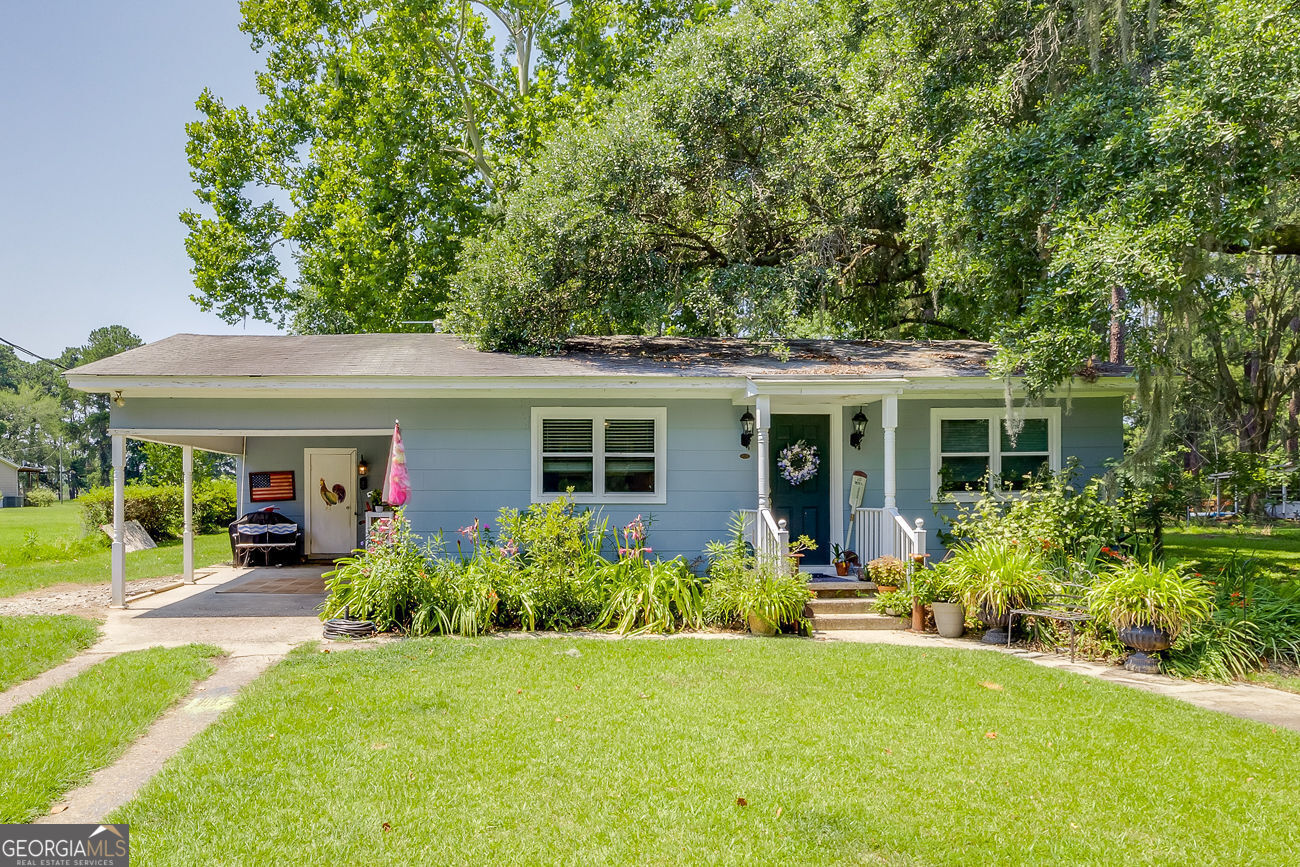 407 Buckhalter Road Savannah, GA 31405 - Photo 1 of 1 a front view of house with yard and green space