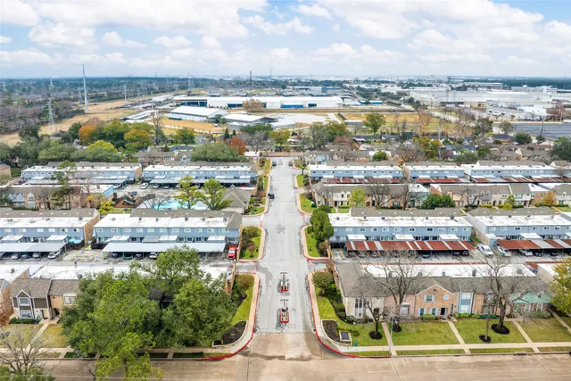 an aerial view of residential building and lake