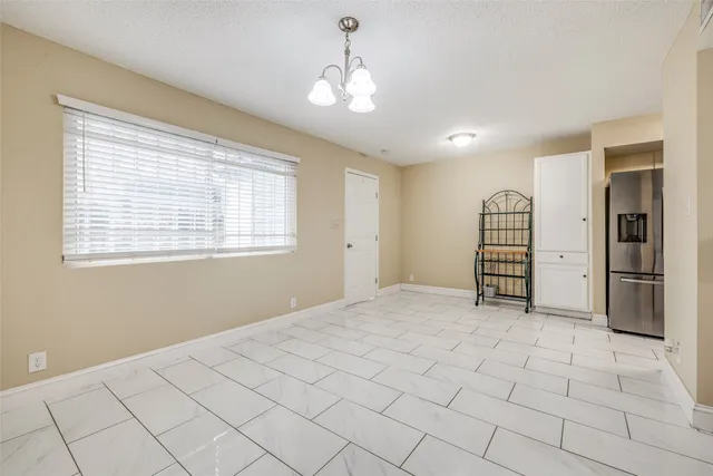 a view of kitchen with furniture and refrigerator