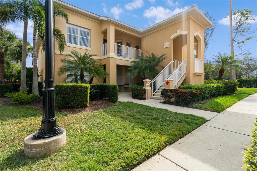 7146 Boca Grove Place, Unit 201 Lakewood Ranch, FL 34202 - Photo 1 of 1 a front view of a house with garden