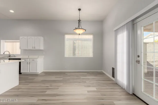 a very nice looking room with a wooden floor and windows