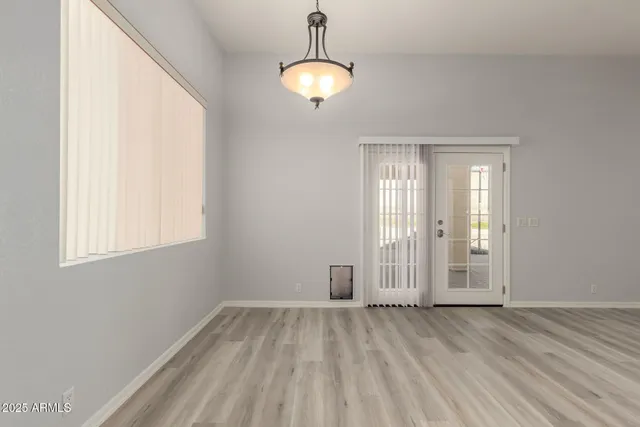 a view of a room with wooden floor and windows