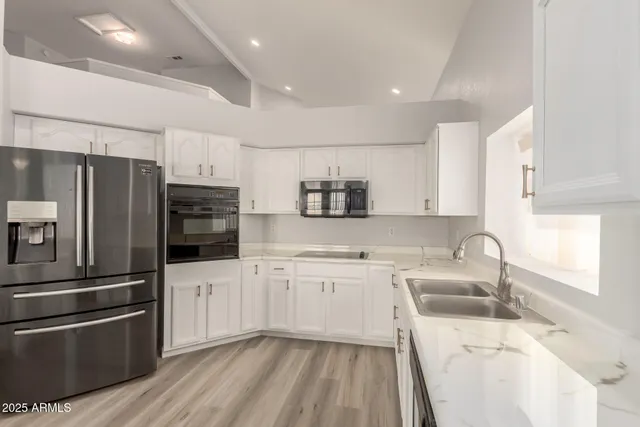a kitchen with a sink stainless steel appliances and cabinets