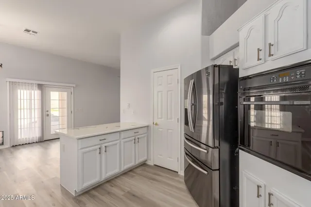 a kitchen with stainless steel appliances a refrigerator and a stove