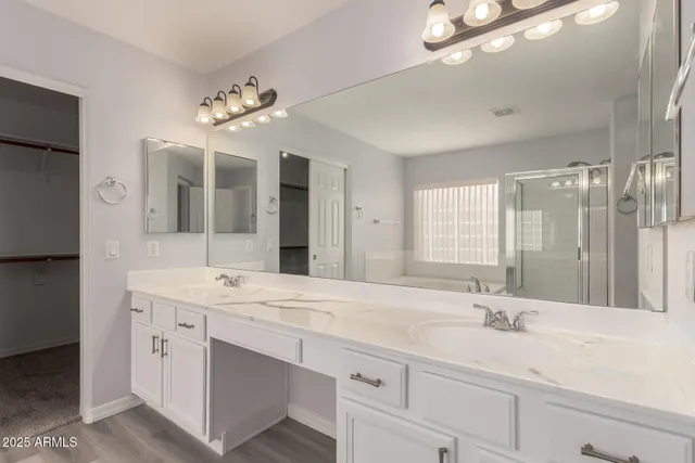 a bathroom with a sink double vanity and a mirror