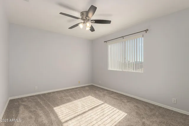 a view of a big room with wooden floor and windows in a room