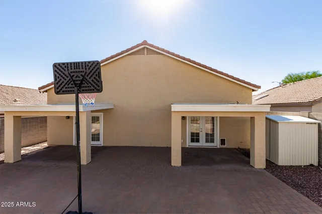 a backyard of a house with table and chairs