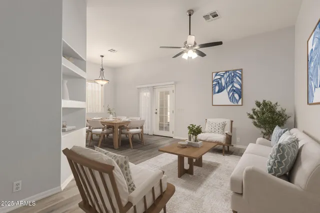 a living room with furniture and a chandelier