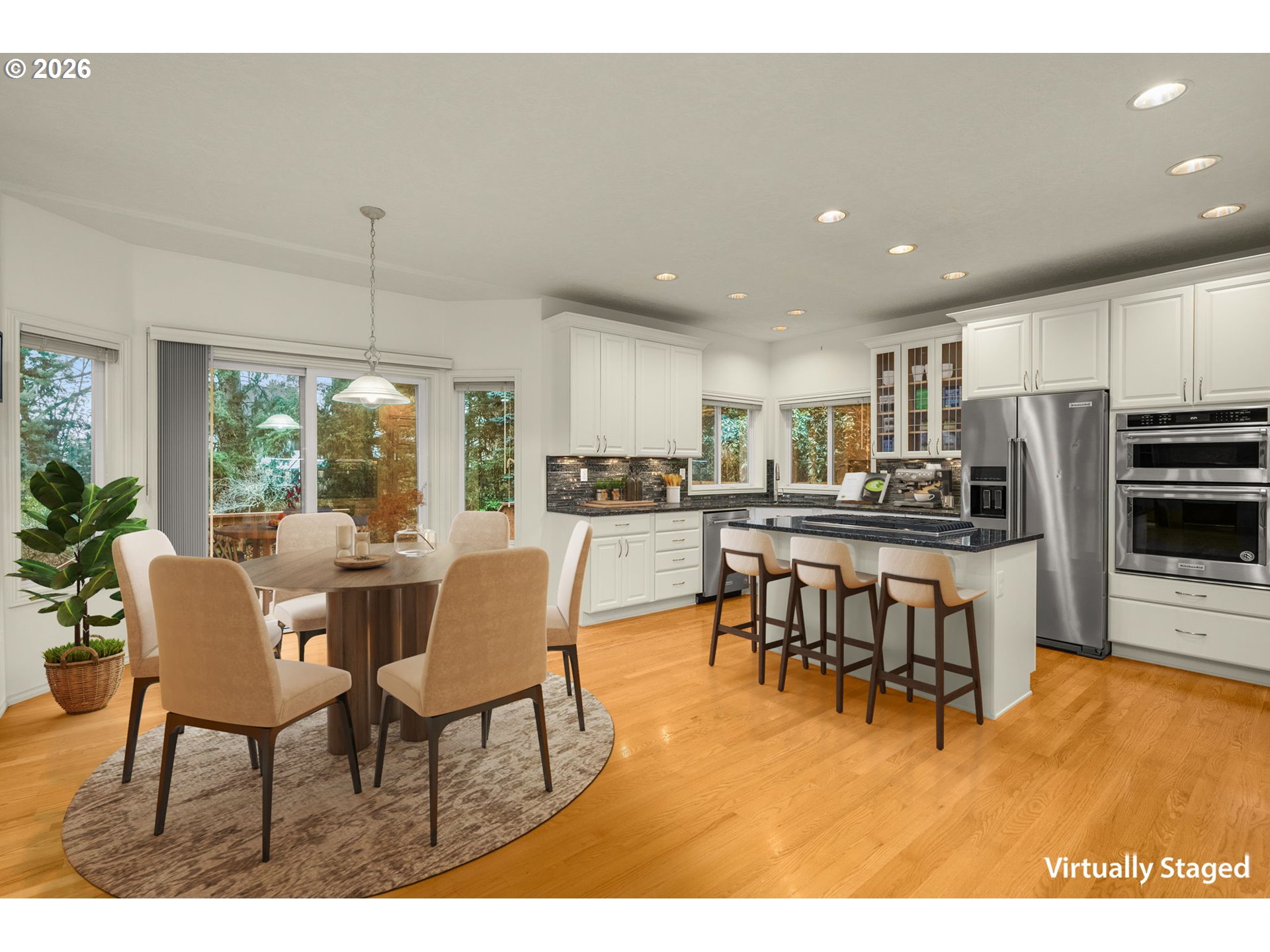9625 Northwest Fleischner Street Portland, OR 97229 - Photo 15 of 39 a dining room with stainless steel appliances kitchen island granite countertop a dining table chairs and granite counter tops