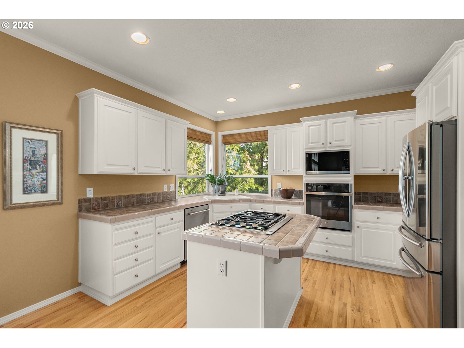 9625 Northwest Fleischner Street Portland, OR 97229 - Photo 16 of 39 a kitchen with stainless steel appliances kitchen island granite countertop a stove a sink and a refrigerator