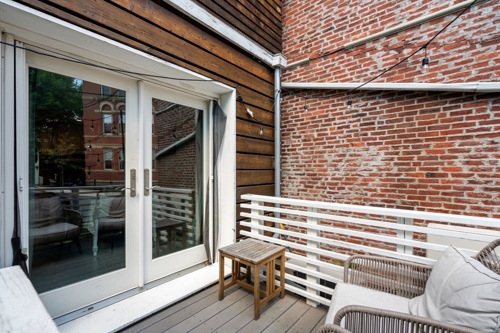 67 Dudley Street, Unit SF Boston, MA 02119 - Photo 22 of 28 a view of a chair and door in the balcony