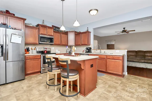 a kitchen with a sink appliances and cabinets
