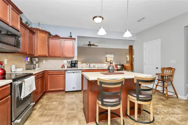 a kitchen that has a table and chairs in it