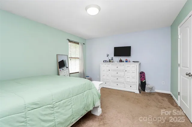 a room with a bed and a tv