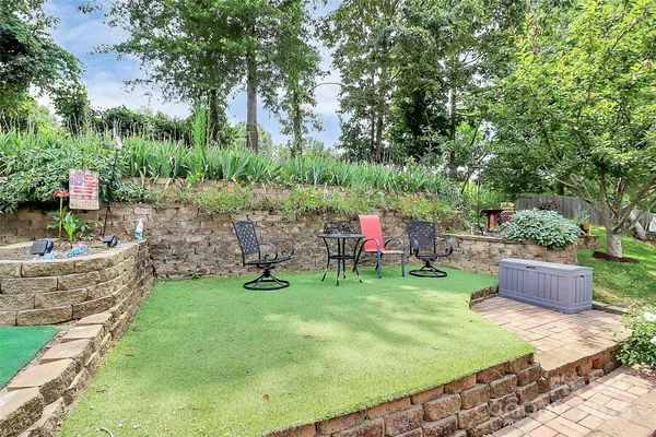 a backyard of a house with outdoor seating