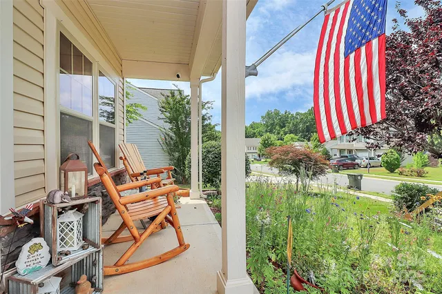 a view of a chairs and table in patio with a small pool