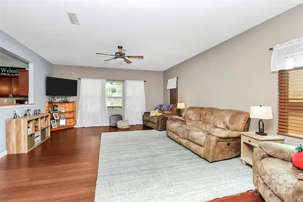 a living room with furniture flat screen tv and wooden floor