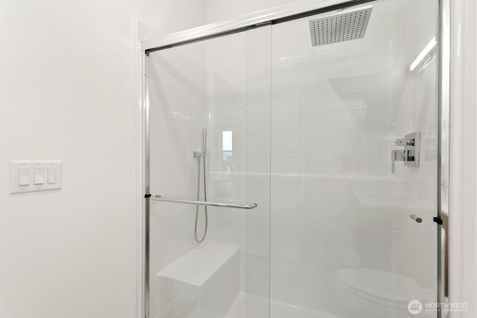 117 Wells Avenue South, Unit D Renton, WA 98057 - Photo 22 of 26 a bathroom with a glass shower door