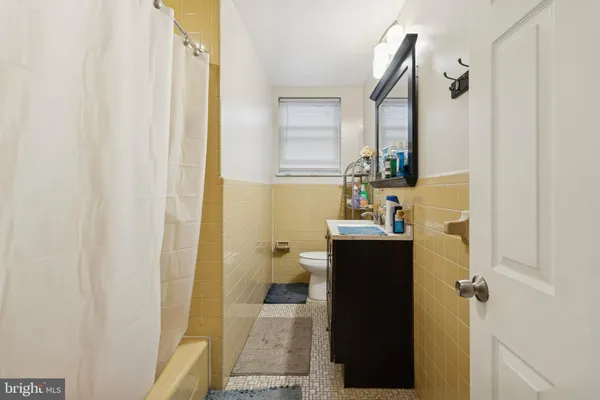 a bathroom with a sink and mirror with toilet