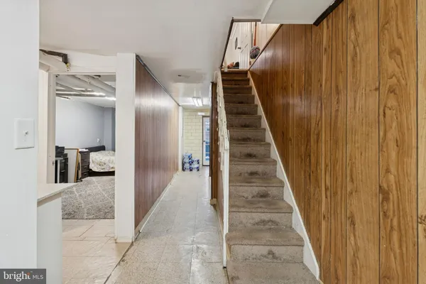a view of a hallway with wooden floor and stairs