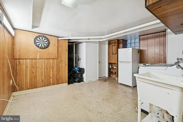 a view of a refrigerator and a utility room with a refrigerator
