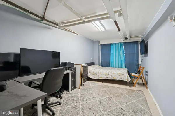 a bedroom with a workspace