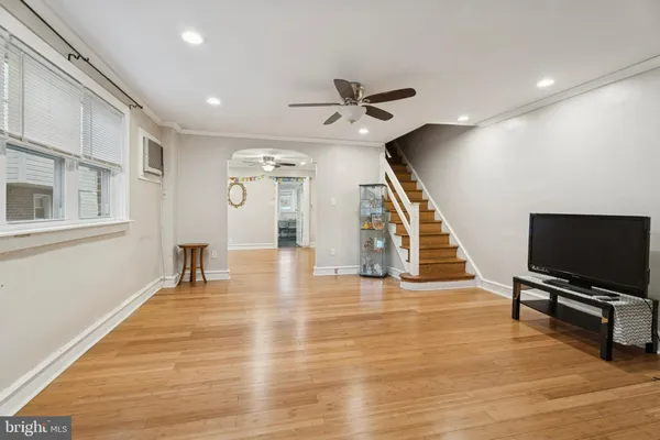 a view of a livingroom with wooden floor and furniture