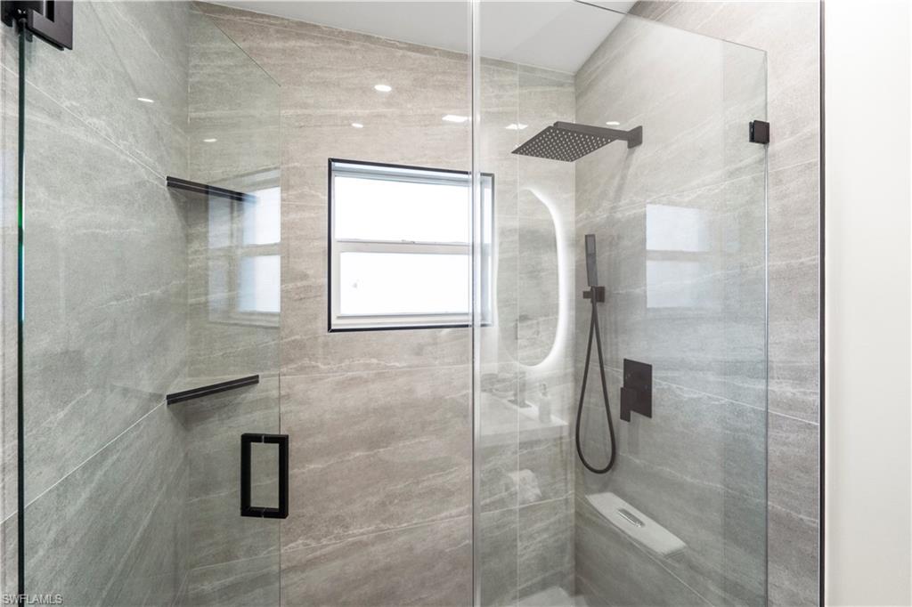 1410 San Marco Road Marco Island, FL 34145 - Photo 26 of 50 a bathroom with a glass shower door