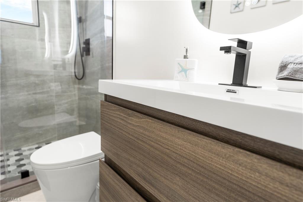 1410 San Marco Road Marco Island, FL 34145 - Photo 29 of 50 a bathroom with a sink a toilet and shower