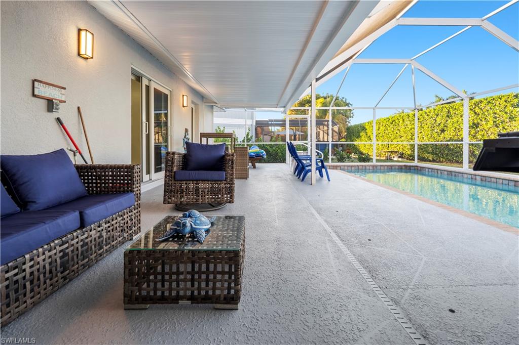 1410 San Marco Road Marco Island, FL 34145 - Photo 34 of 50 a living room with furniture a rug and white walls