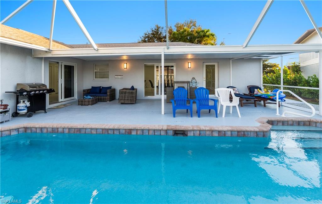 1410 San Marco Road Marco Island, FL 34145 - Photo 37 of 50 a view of a patio with table and chairs under an umbrella