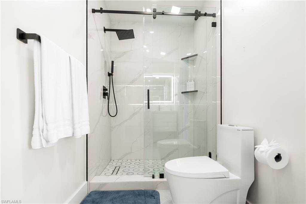 1410 San Marco Road Marco Island, FL 34145 - Photo 41 of 50 a bathroom with a shower toilet and sink