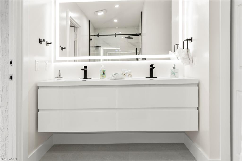 1410 San Marco Road Marco Island, FL 34145 - Photo 42 of 50 a bathroom with a sink and a mirror