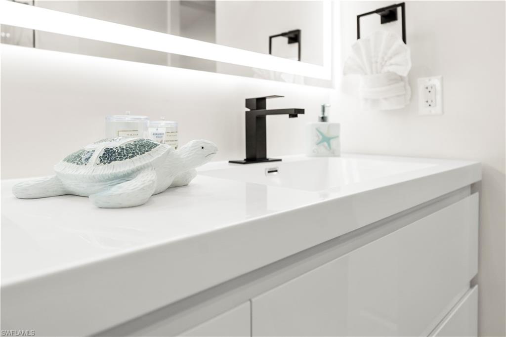 1410 San Marco Road Marco Island, FL 34145 - Photo 43 of 50 a bathroom with a sink and a mirror