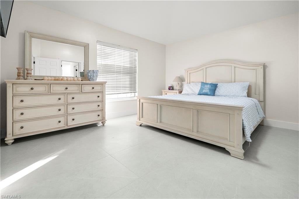 1410 San Marco Road Marco Island, FL 34145 - Photo 46 of 50 a room with a bed and a mirror in it