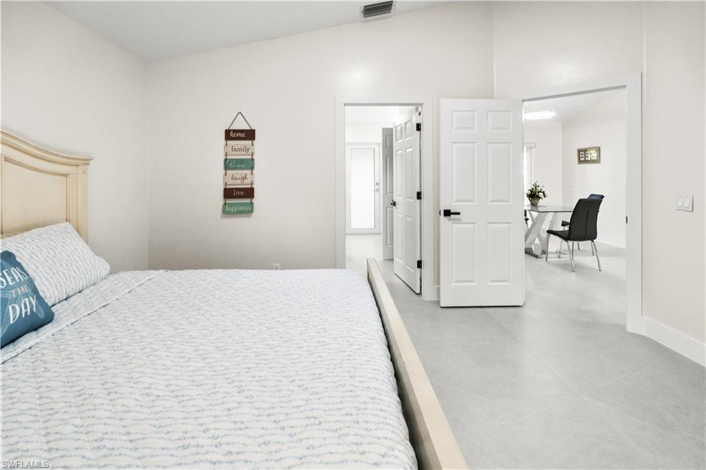 1410 San Marco Road Marco Island, FL 34145 - Photo 48 of 50 a spacious bedroom with a bed and a couch