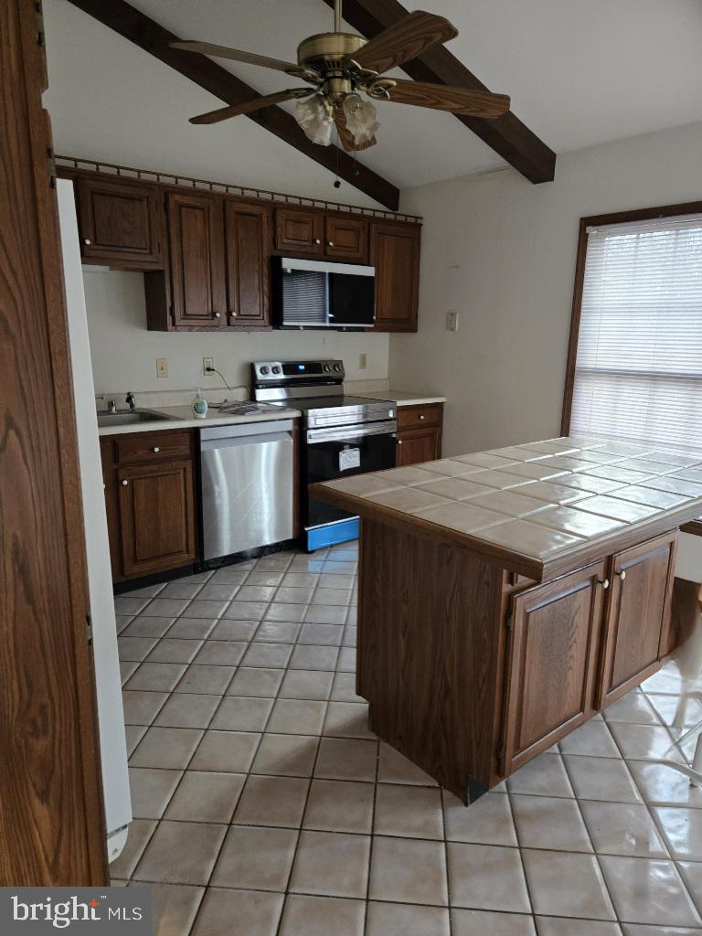 404 Beach Drive Annapolis, MD 21403 - Photo 11 of 25 a kitchen with stainless steel appliances granite countertop a stove top oven a sink a counter top space and cabinets