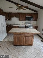 404 Beach Drive Annapolis, MD 21403 - Photo 12 of 25 a kitchen with stainless steel appliances granite countertop a stove a microwave and a sink