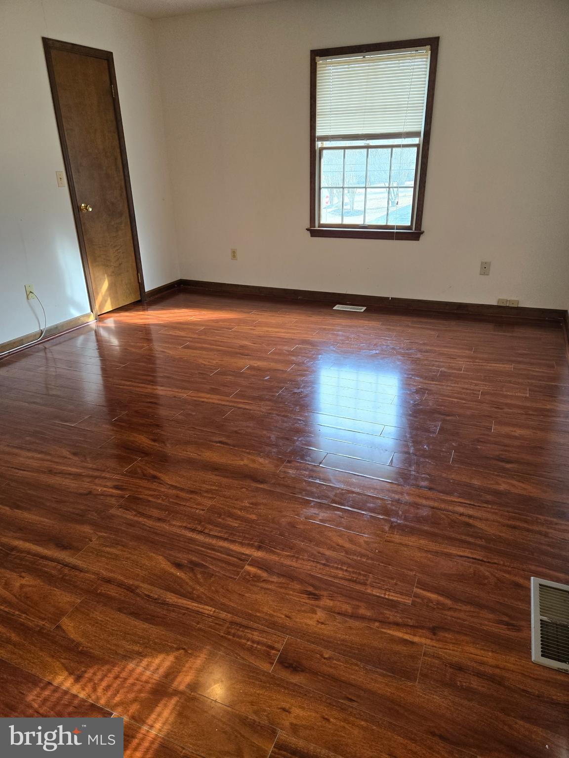 404 Beach Drive Annapolis, MD 21403 - Photo 13 of 25 an empty room with wooden floor and windows