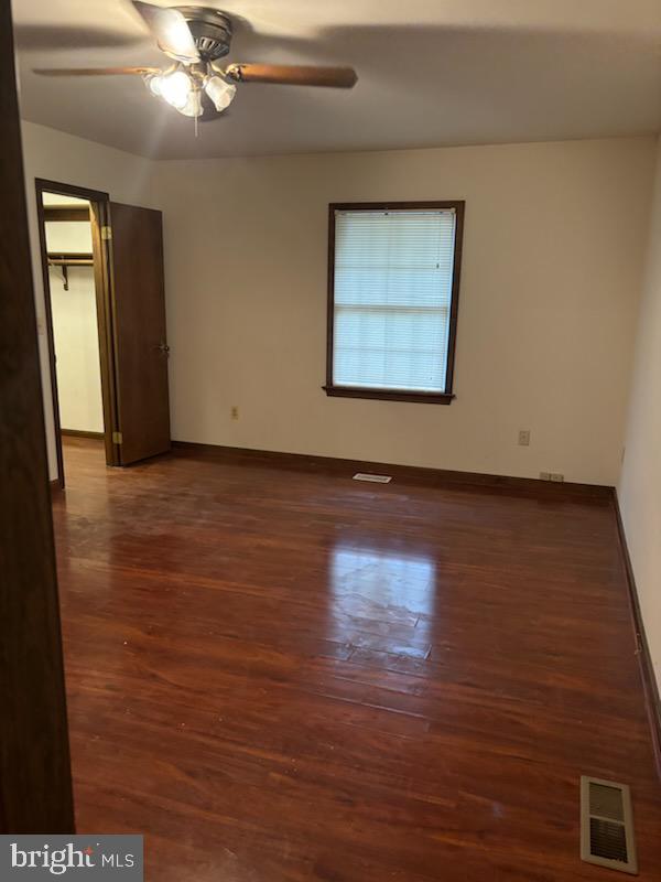 404 Beach Drive Annapolis, MD 21403 - Photo 15 of 25 an empty room with wooden floor chandelier fan and windows