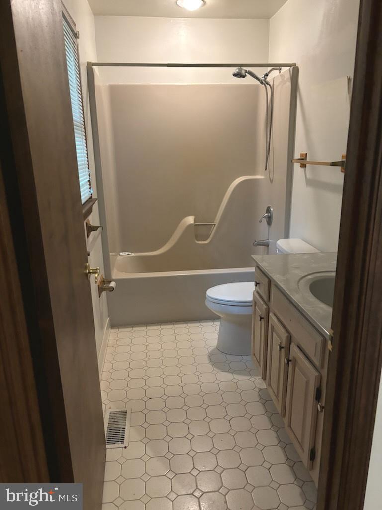 404 Beach Drive Annapolis, MD 21403 - Photo 18 of 25 a bathroom with a granite countertop sink toilet and shower