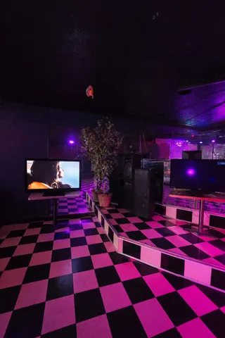 a room with lots of white walls and a rug