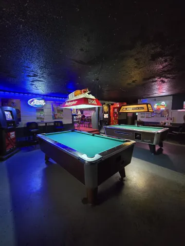 a room with stainless steel appliances lots of wooden furniture