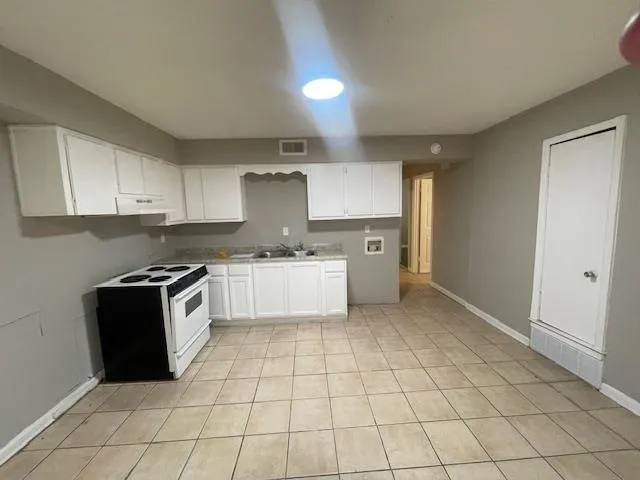 a kitchen with a stove a sink and a refrigerator