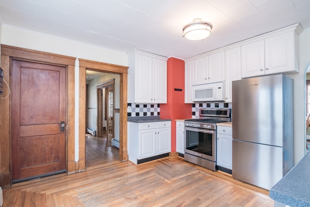 2 Oak Street Easthampton, MA 01027 - Photo 12 of 42 a kitchen with a refrigerator and a stove top oven