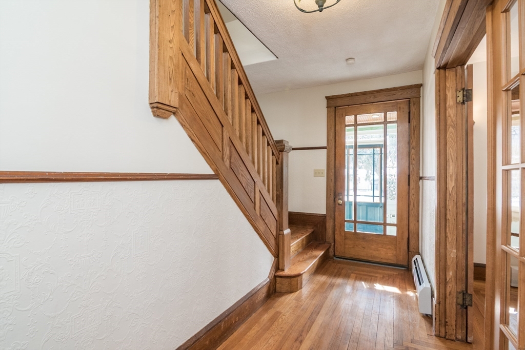 2 Oak Street Easthampton, MA 01027 - Photo 18 of 42 a view of a hallway with wooden floor and staircase