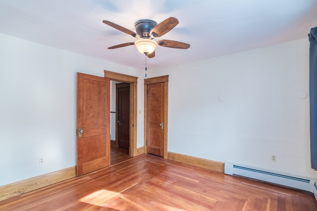 2 Oak Street Easthampton, MA 01027 - Photo 21 of 42 a view of an empty room with wooden floor and a ceiling fan
