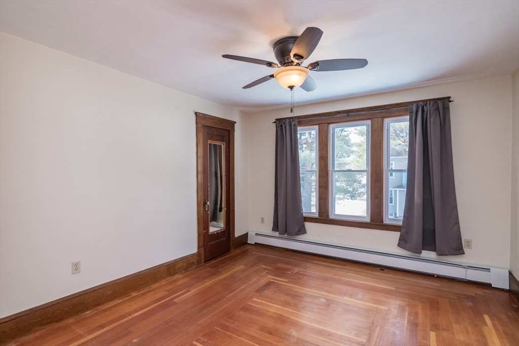 2 Oak Street Easthampton, MA 01027 - Photo 22 of 42 a view of an empty room with a window and wooden floor
